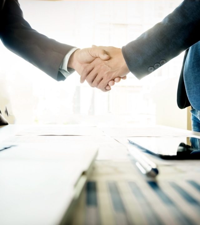 Businessmen shaking hands during a meeting.